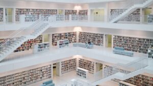 Modern library interior with white shelves and stairs